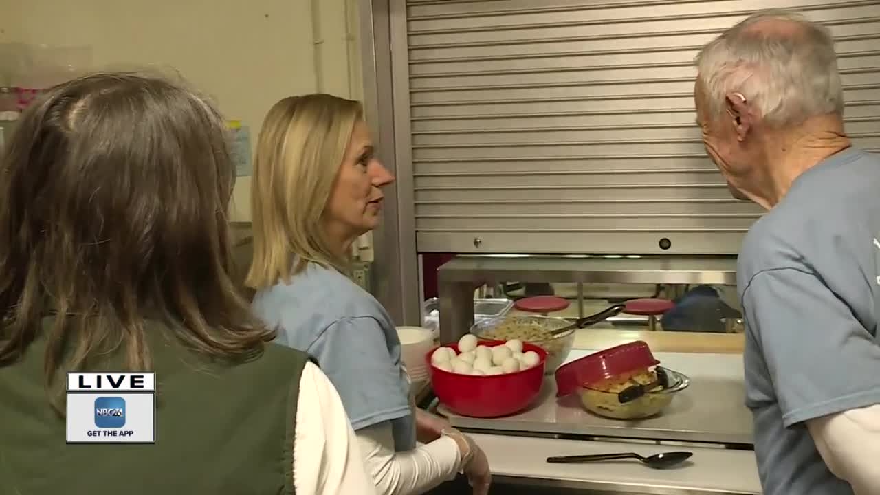 Volunteers help with serving breakfast at local shelter
