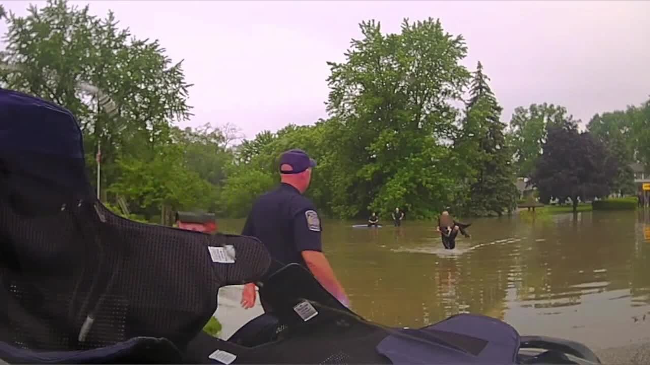 Clinton Township police rescue 82-year-old trapped in vehicle in rising flood waters