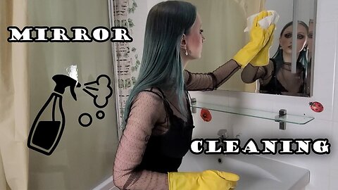 Cleaning the mirror in yellow rubber gloves