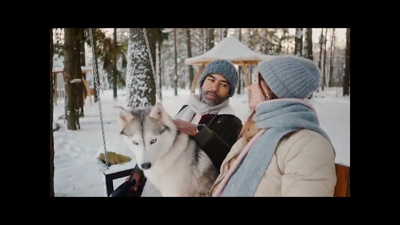 Couple Enjoying with their Dog in Snow