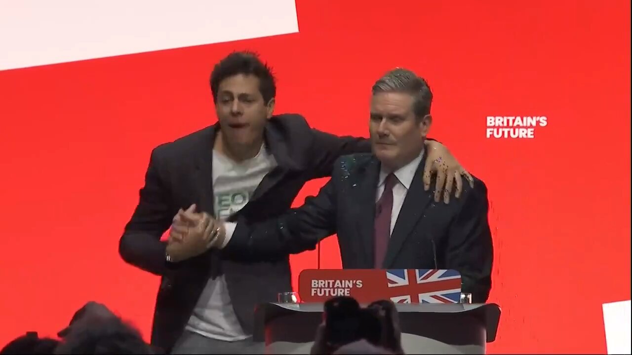 Witness a protester sprinkling glitter on UK’s PM Keir Rodney Starmer before being escorted away
