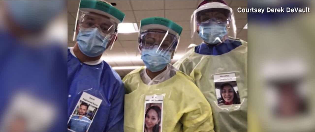 Healthcare workers wear photos outside PPE