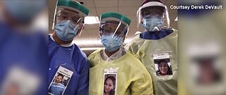 Healthcare workers wear photos outside PPE