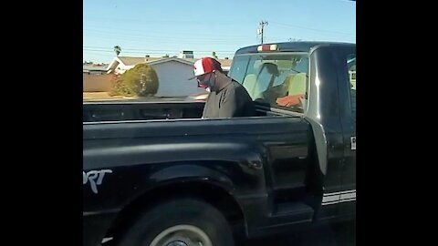 Kid will risk life to ride in a truck bed, but has to wear a face diaper!