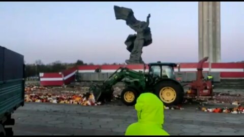 Work crews remove a huge amount of flowers at the Victory Monument in Riga, Latvia on the morning of May 10th