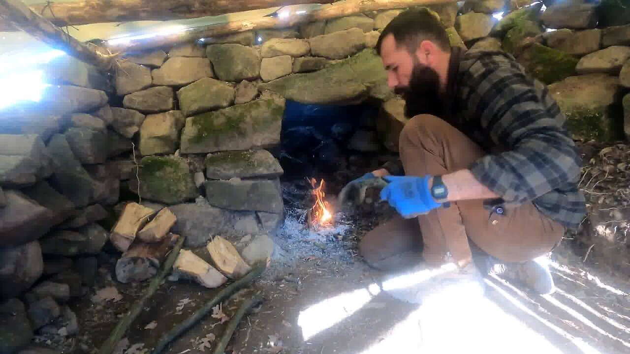 Fireplace Inside Survival Shelter Made of Stone and Wood