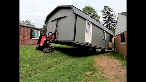 Removing a shed from a backyard.