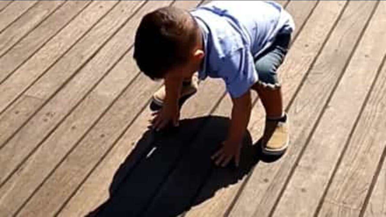 Little boy is afraid of his own shadow