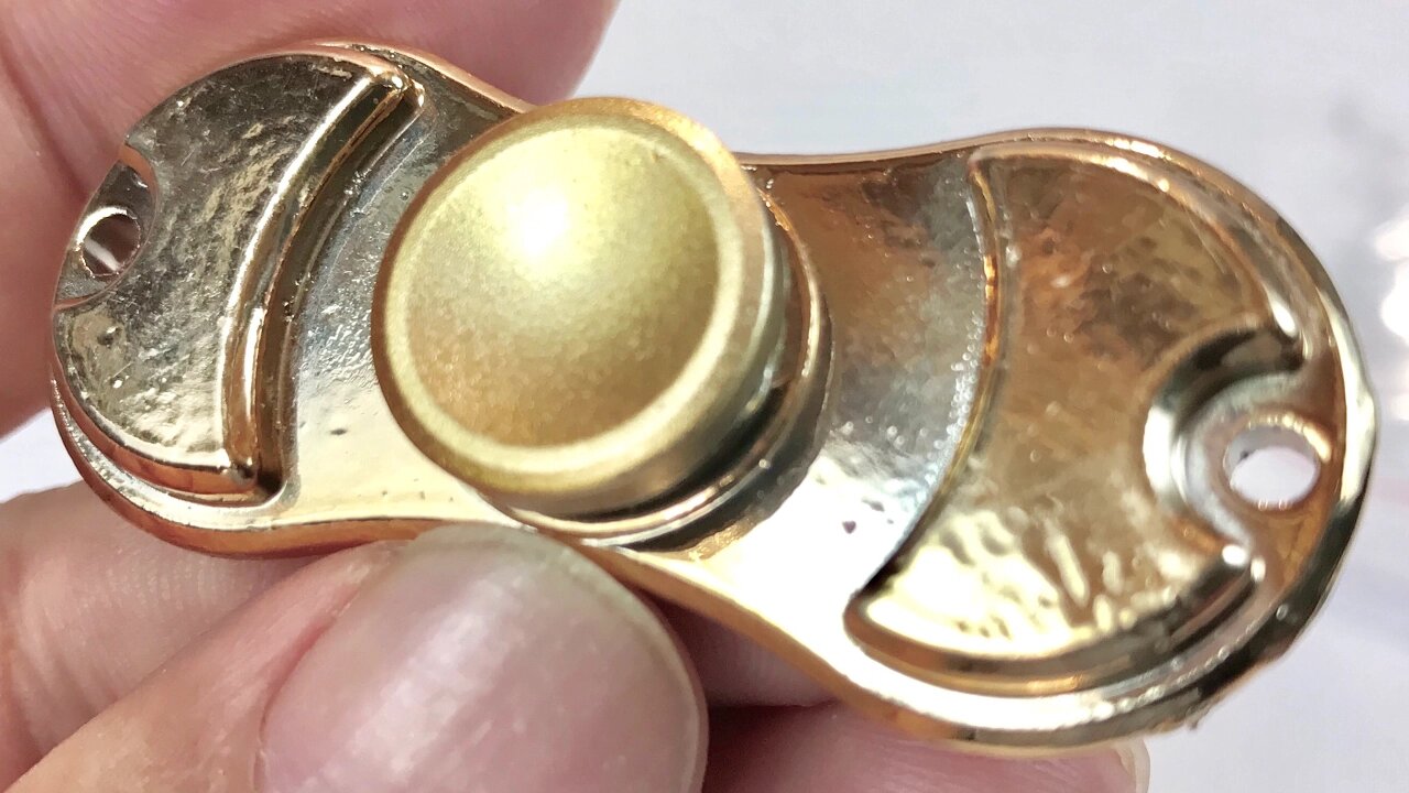 Gold toned metal hand fidget spinner toy giveaway