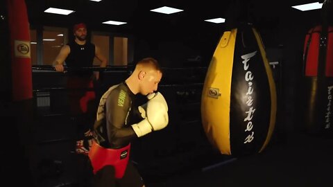 A Boxer Hitting A Punching Bag In Training