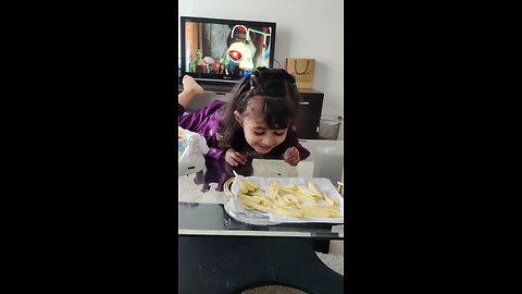 cute baby eating fries and watching YouTube