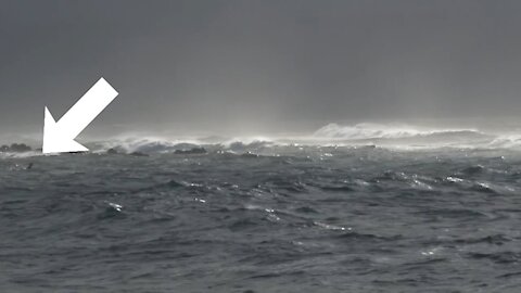 alone surfer into the storm