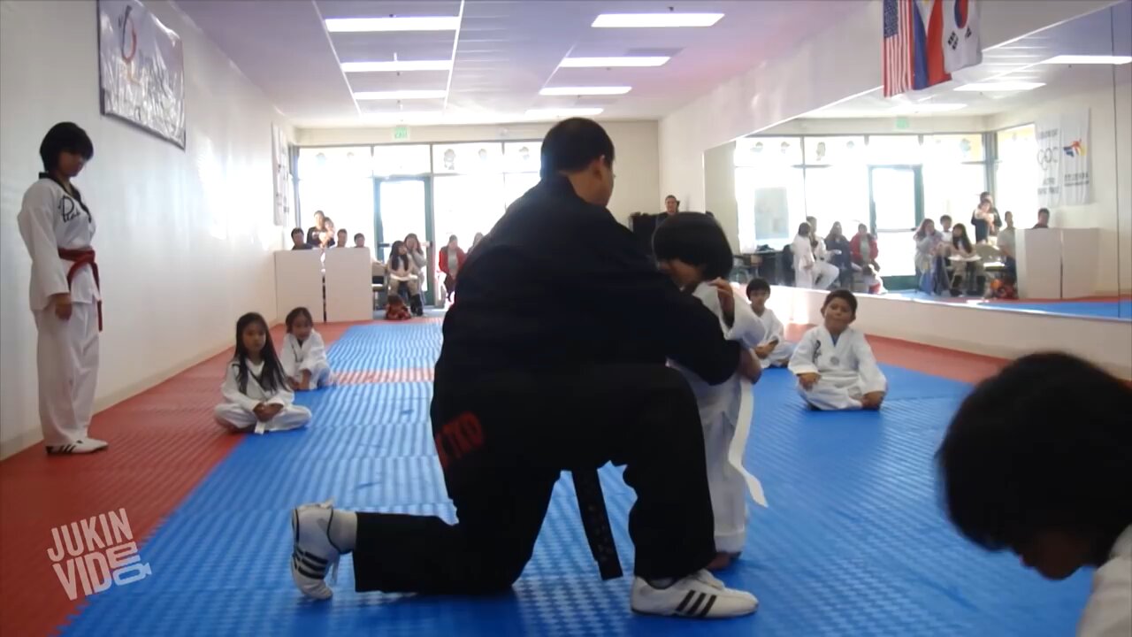 Little boy is trying to break a board as part of the Taekwondo| funny activity