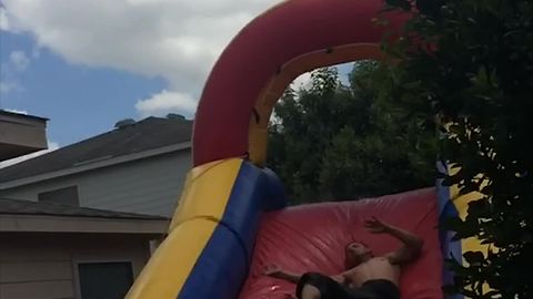 Man Leaps Off Roof Into Bounce Slide And Into A Tree