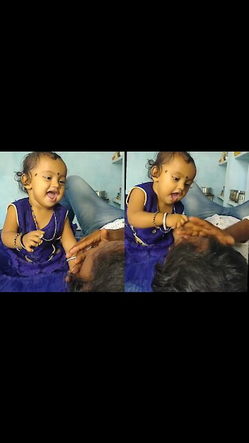 Baby on bed adorably plays hide-and-seek with her dad