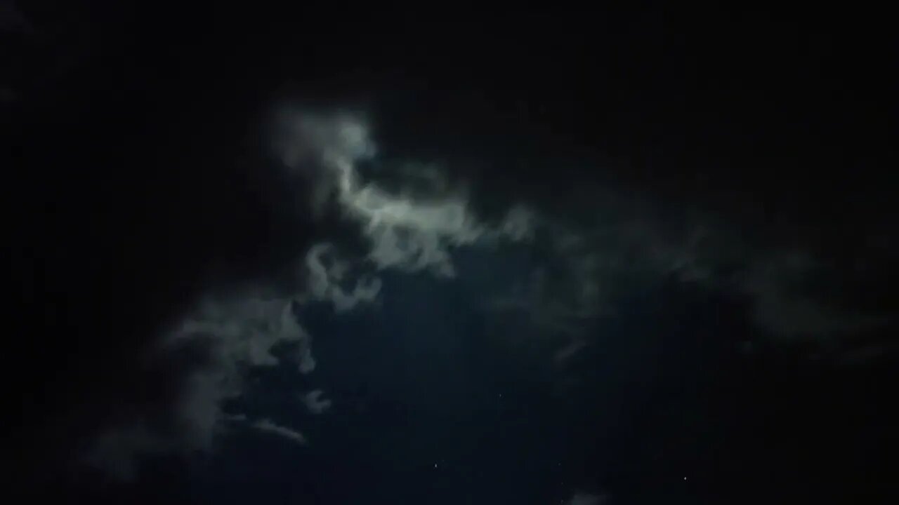 Storm Clouds passing by the Moon