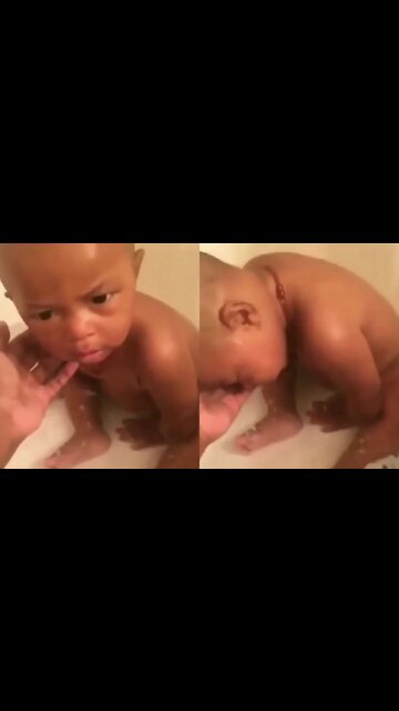 Sleepy baby taking a bath