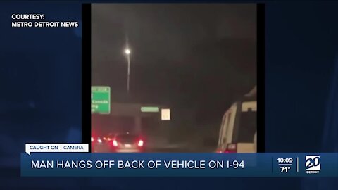 Man hangs off back of vehicle on I-94