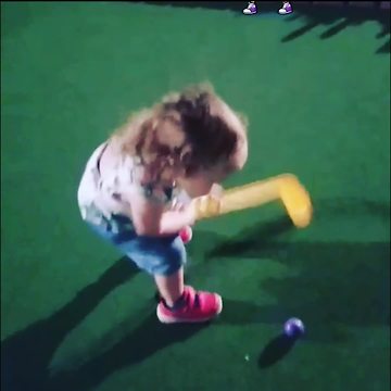 A Tot Girl Tries To Putt But Misses Ball Every Time