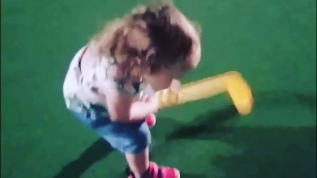 A Tot Girl Tries To Putt But Misses Ball Every Time