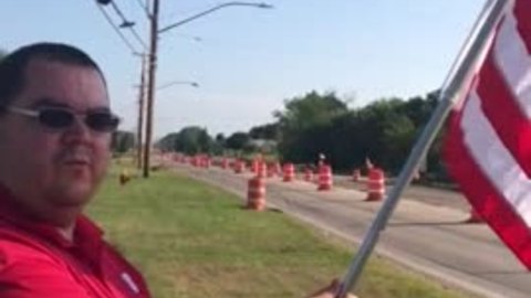 Oak Creek resident bears flag to pay respect to Officer Michalski