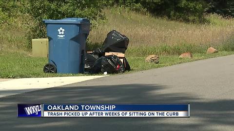 Trash picked up after weeks of sitting on the curb in Oakland Township