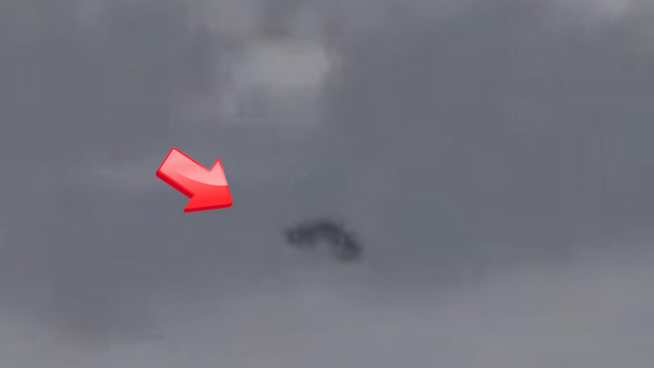 Disc-shaped UFO seen over cloudy sky taken from an aircraft window [Space]