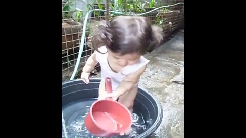 Super cute filipino-european baby girl plays with water- simple pleasures of life in the Philippines