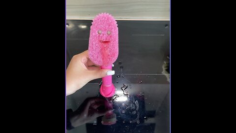 Cleaning the stovetop with scrub daddy
