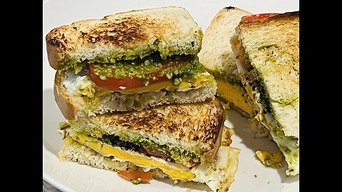 Fried egg, tomato with pesto sandwich