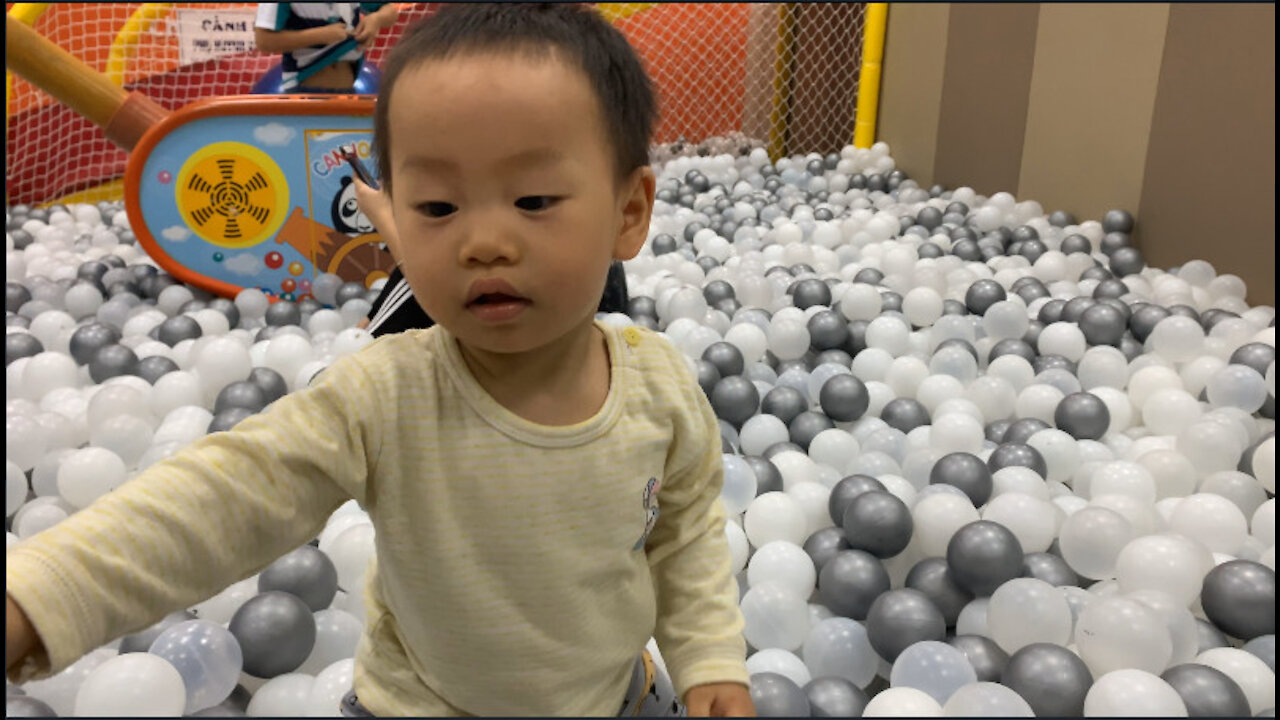 Cute baby playing ball house with dad