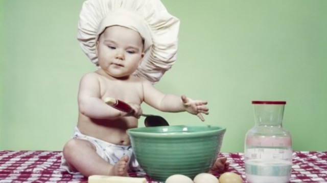 Toddler bakes a cake with dad.