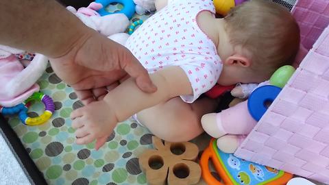 "Toddler Girl Falls Asleep in Toy Box"