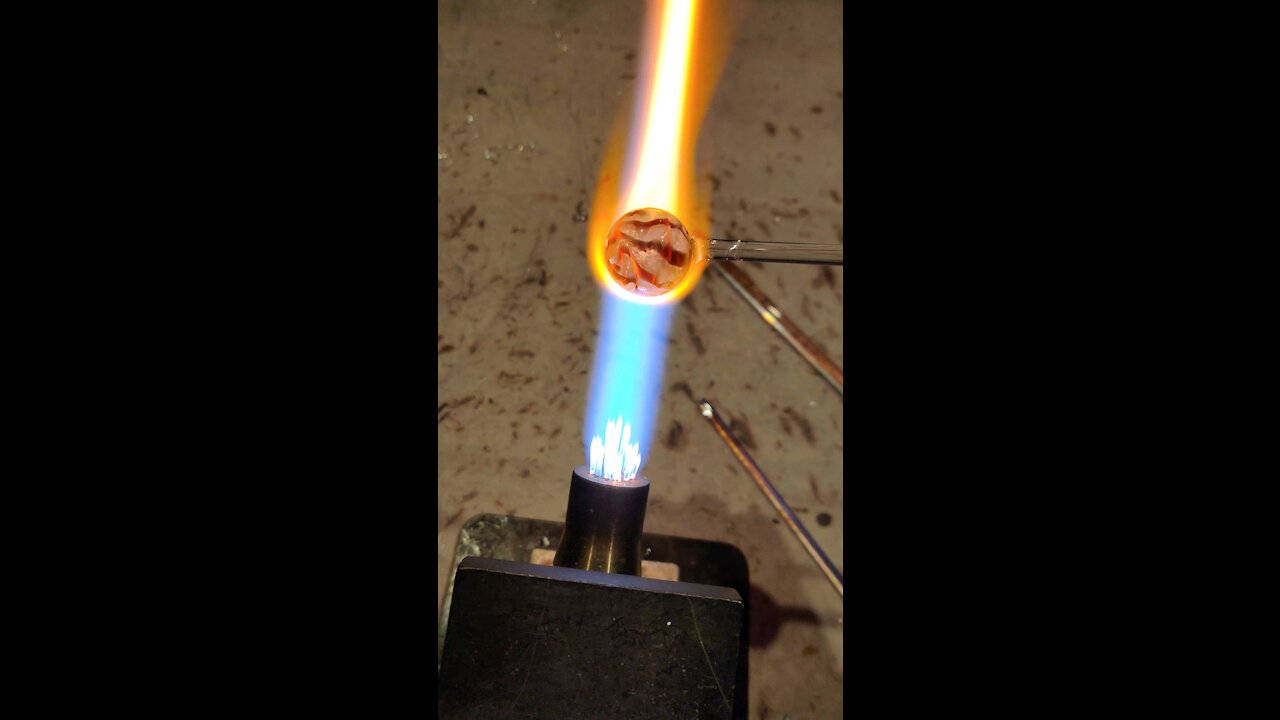 Molten glass marble in the making