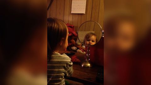 Little Girl Loves Her Reflection