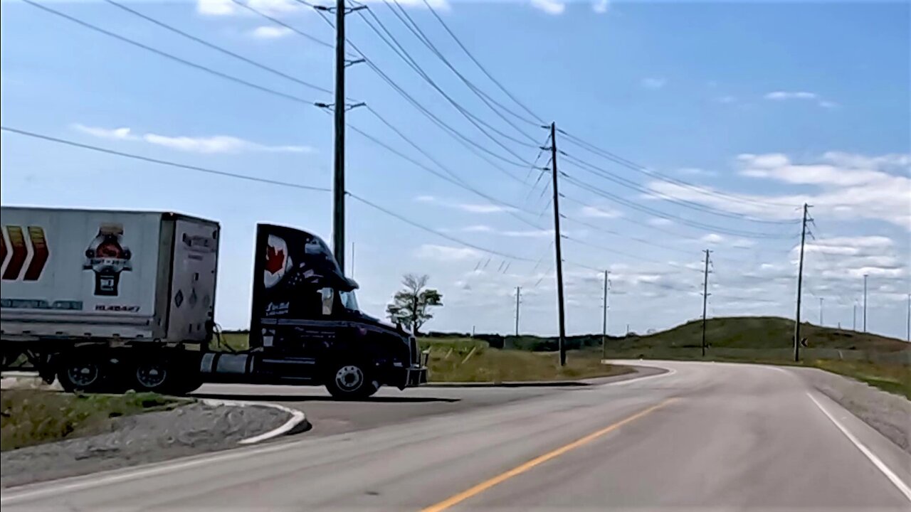 Oblivious truck driver forces car onto the shoulder of the road