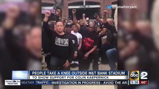 Fans show support for Colin Kaepernick by kneeling outside M&T Bank Stadium