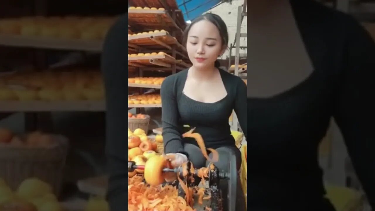 Beautiful Chinese Girl Works Hard Peeling Fruit