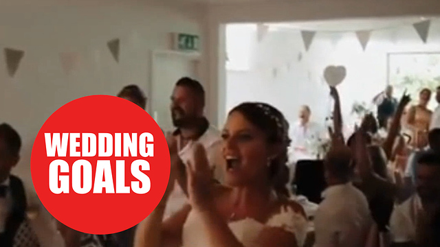 Wedding couple going wild as England score as they cut cake