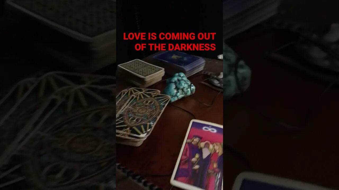 Tarot Card on the floor SPIRIT NEEDS YOU TO KNOW LOVE IS COMING OUT OF THE DARKNESS