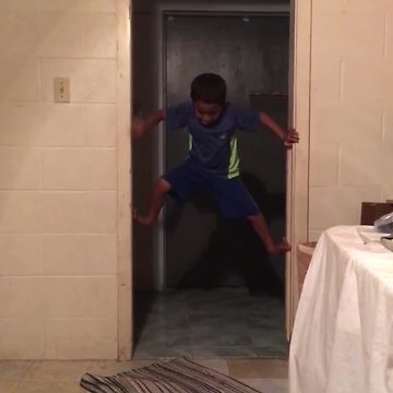 Ninja Kid Climbs Up A Doorframe, But Fails At Getting Down
