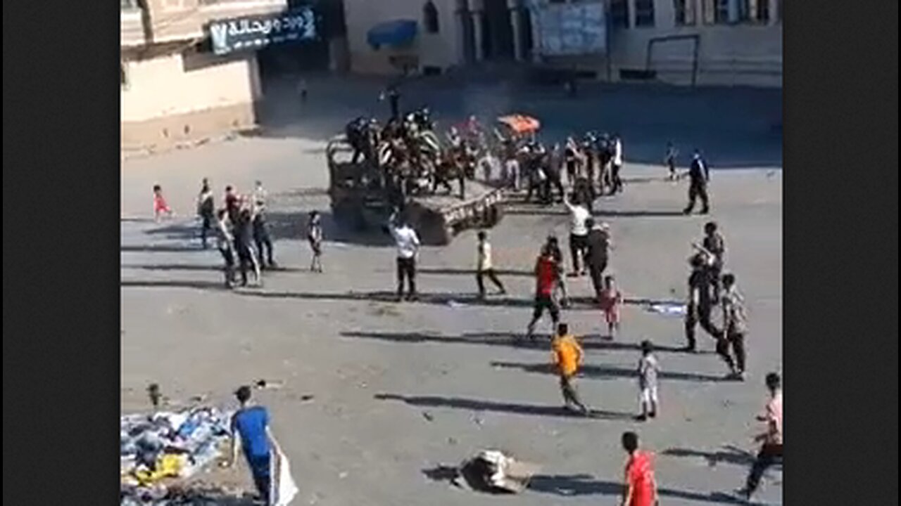 The children of Gaza rejoice, playing on top of an armored truck seized by Palestinians