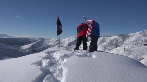 American Legion members snowmobile to replace the flags at a special memorial