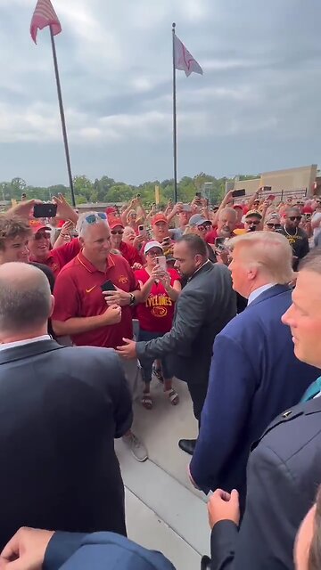 Trump shakes hands with fans as he makes his way through big crowds