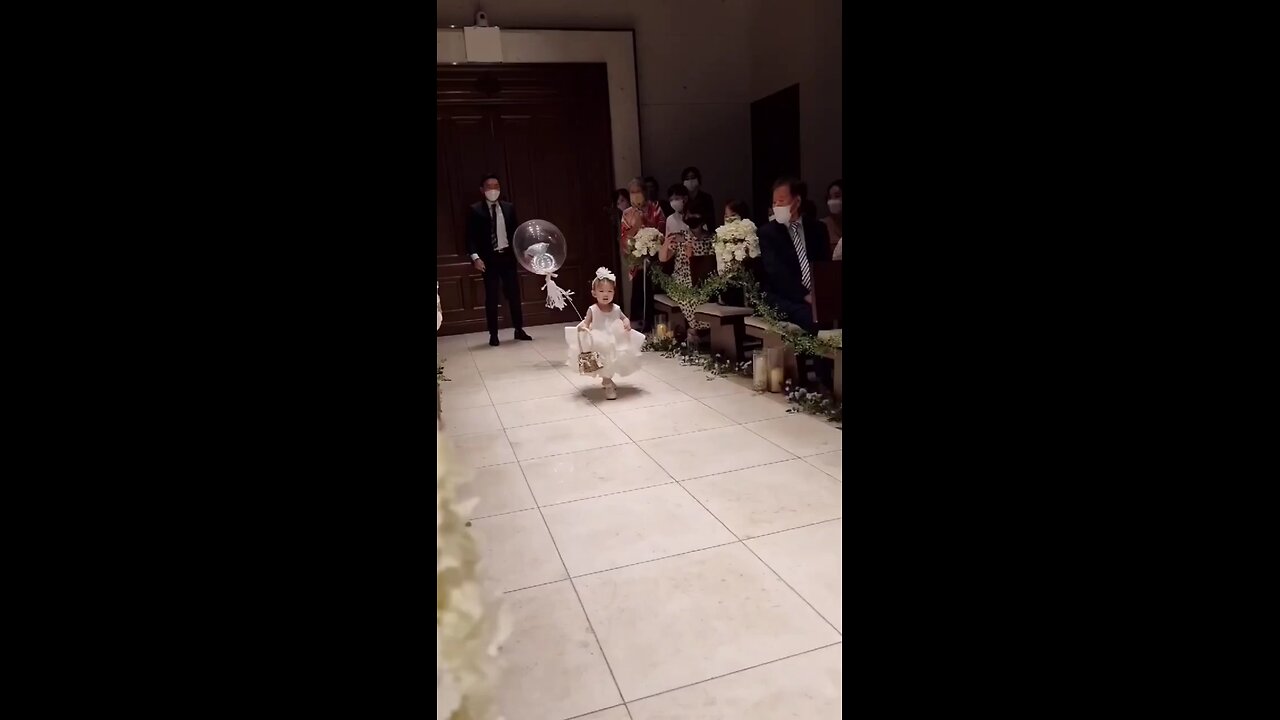 how cute baby girl serve ring basket to the couple