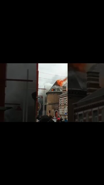 A burning spire falls onto a street in #Binche, #Belgium.