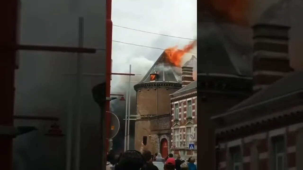A burning spire falls onto a street in #Binche, #Belgium.