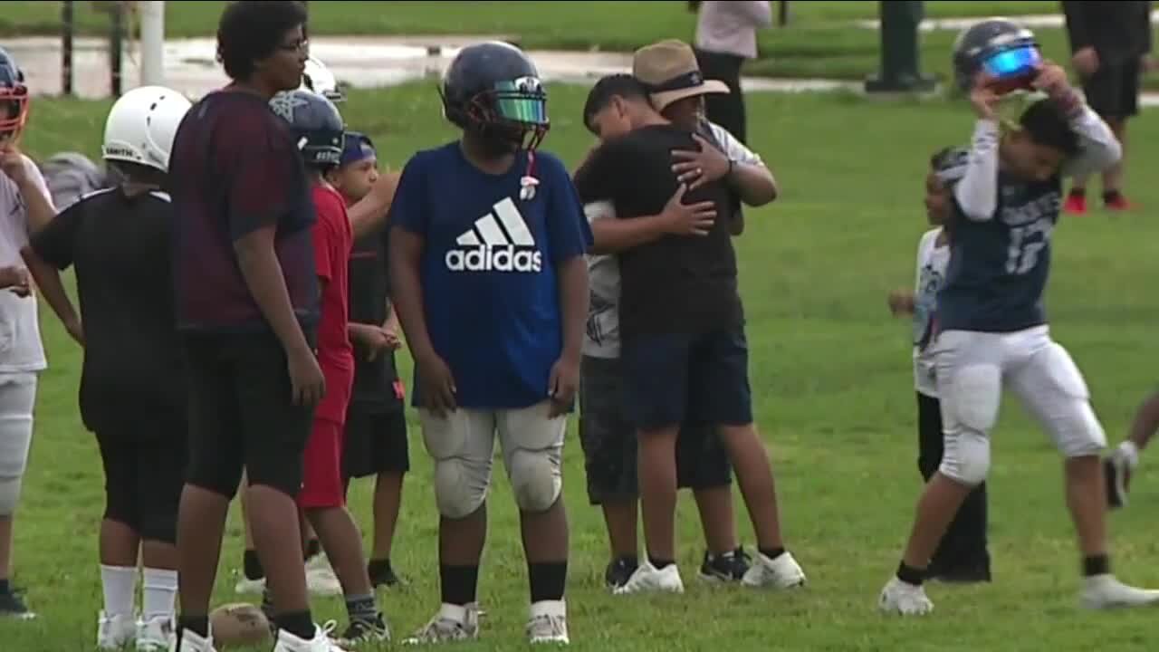 Coach teaches players the game of football an the importance of helping others