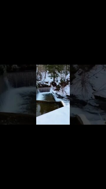 Snow by a waterfall in canada
