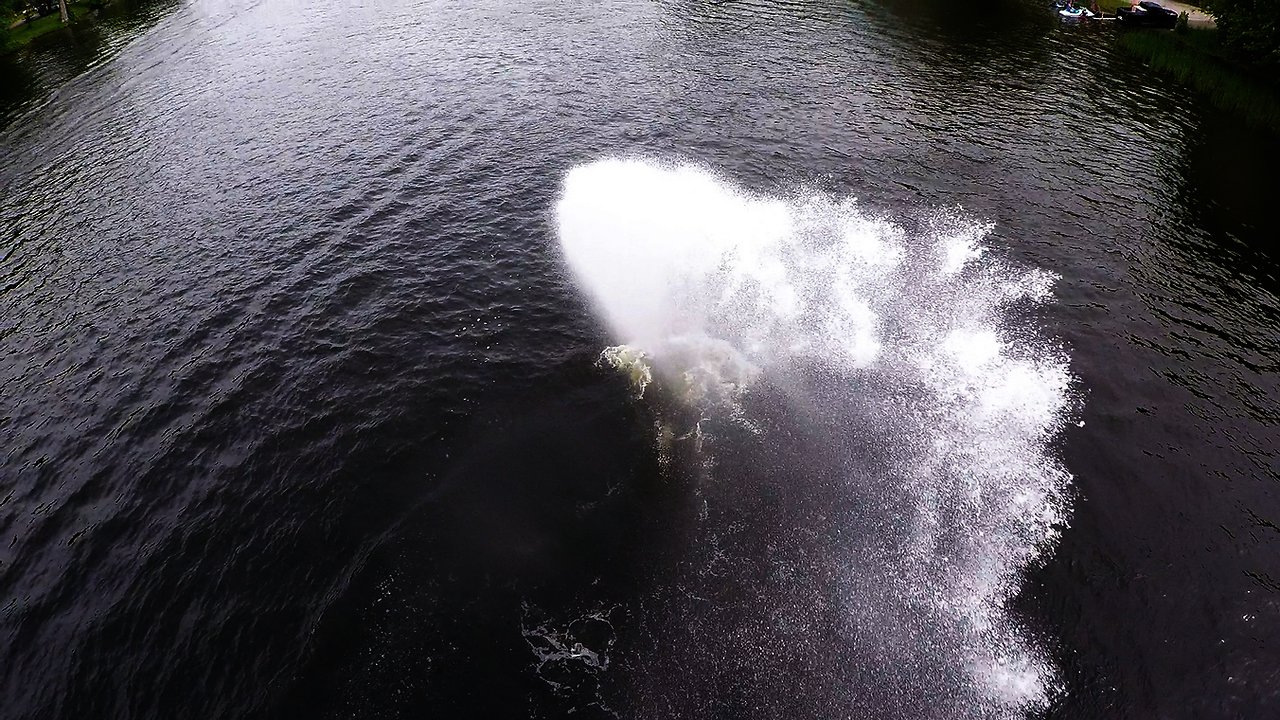 Jet skier's unbelievably skillful prank drenches cyclist on bridge high above